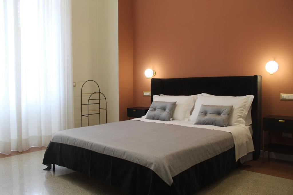 a bedroom with a large bed with two pillows at Sant'Agostino - Luxury Rooms in Messina