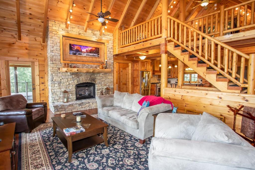 a living room with a couch and a fireplace at Malone Bay On Kerr Scott Lake in Wilkesboro