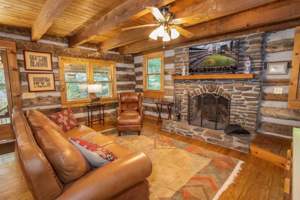 a living room with a couch and a fireplace at The Berry Patch in Blowing Rock
