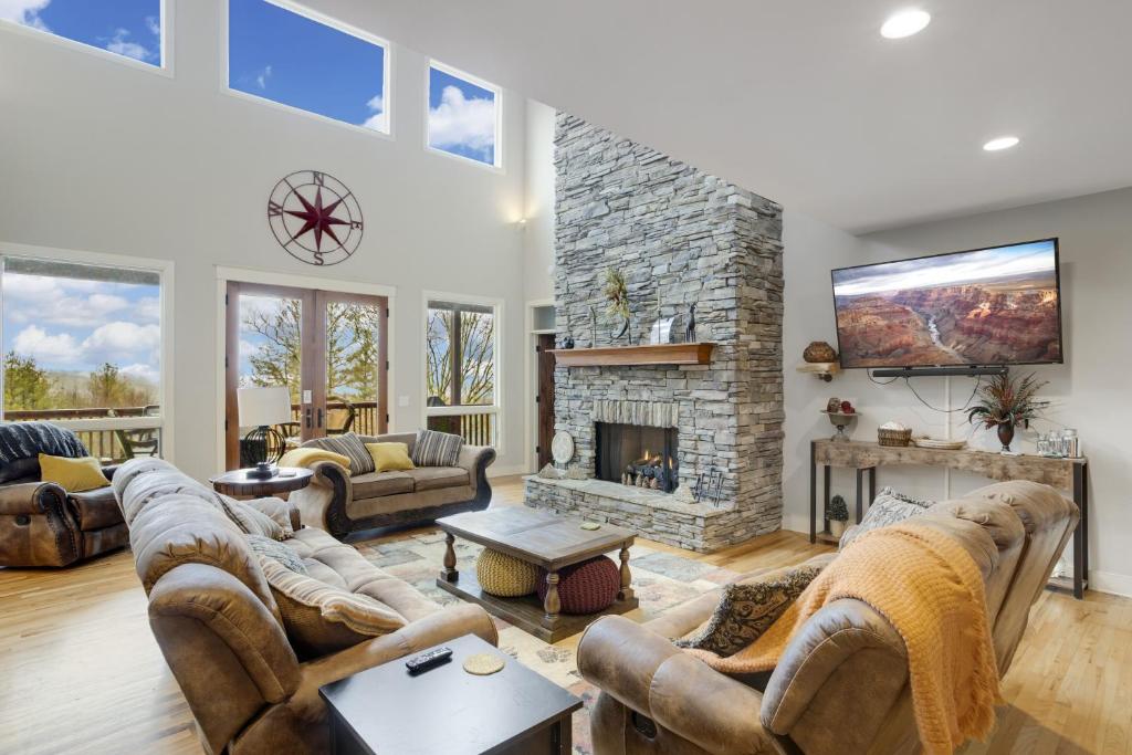 a living room with couches and a fireplace at The Pointe at North View in Banner Elk