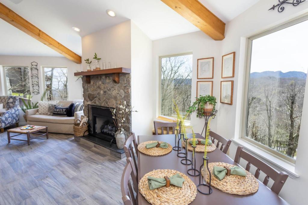 a living room with a table and a fireplace at Top Of The Hill in Seven Devils