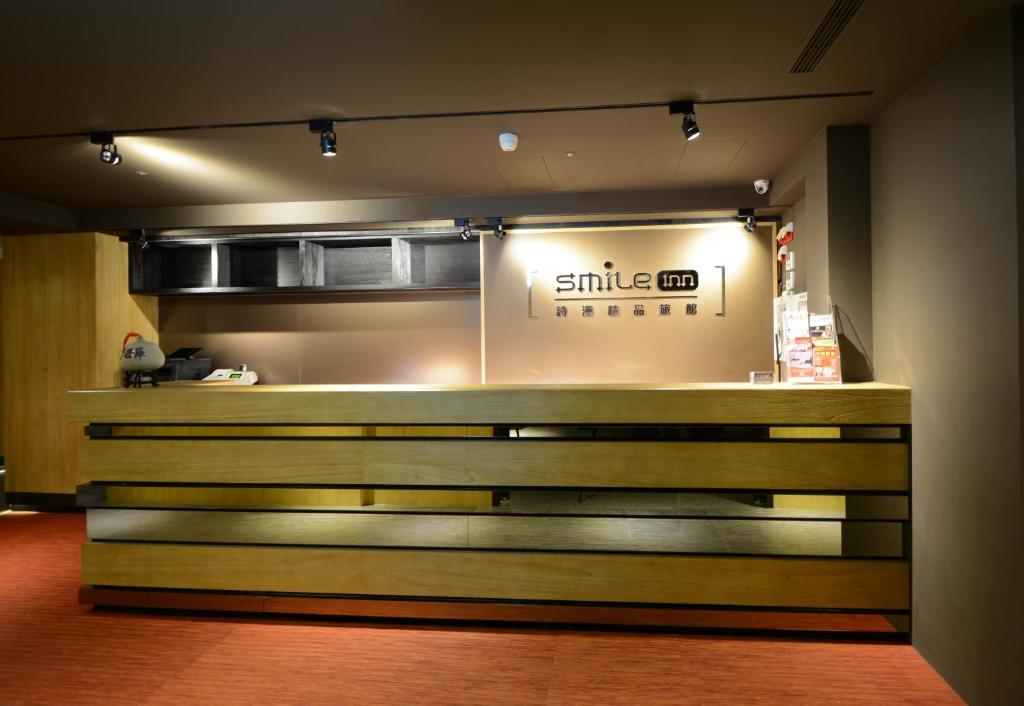 a counter in a restaurant with a smiley booth at Smile Inn - Taipei Main Station in Taipei