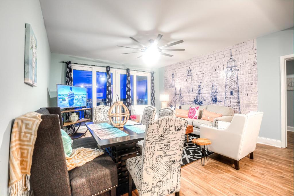 a living room with furniture and a brick wall at Laketown Wharf Resort 631 By Aneliya in Panama City Beach
