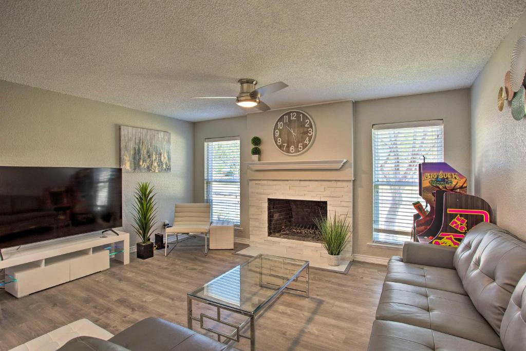 a living room with a couch and a fireplace at Bright, Airy Home with Pool and Grill! in Richardson