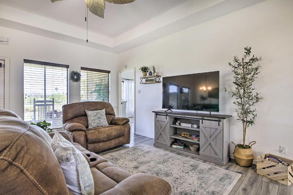 a living room with a tv and a couch and chairs at Vacation Home Rental Near South Padre Island in Laguna Vista
