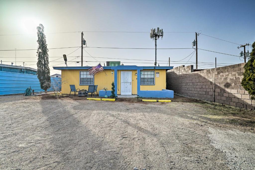 a small yellow and blue house on a dirt road at Central El Paso Home with Fire Pit! in El Paso