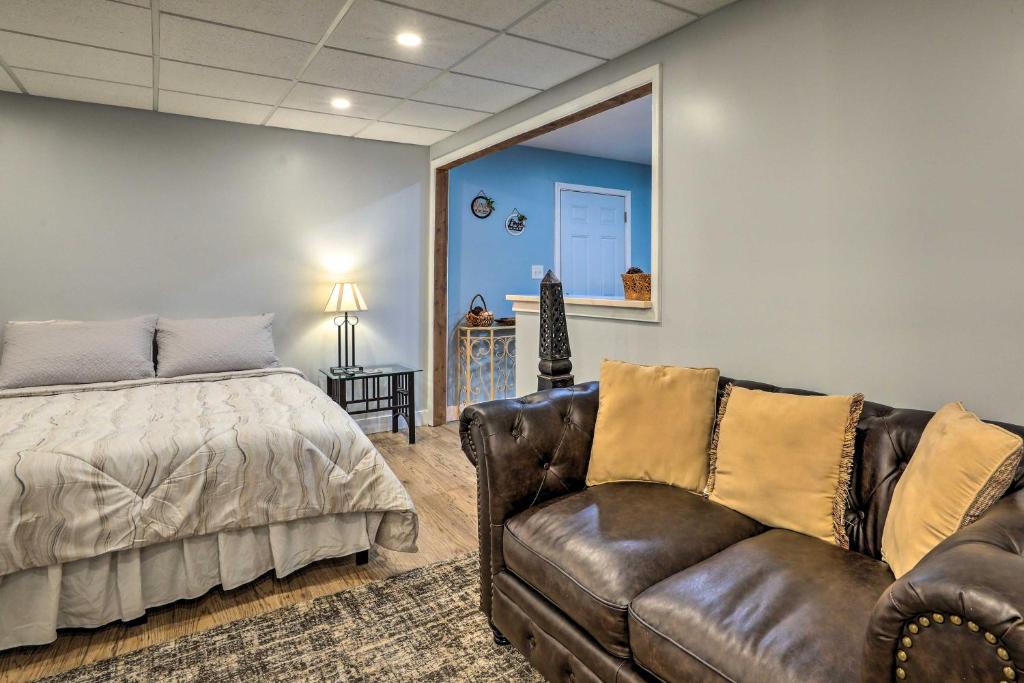 a bedroom with a bed and a couch and a chair at Atlanta Area Studio ~ 3 Mi to Gas South Arena! in Lawrenceville