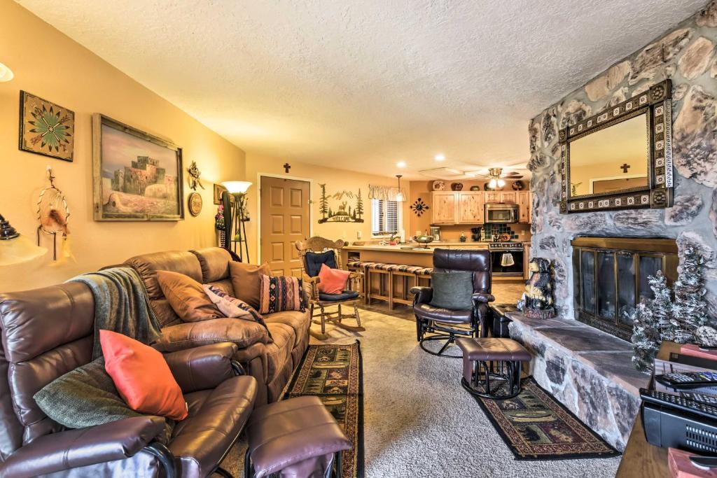 a living room with a couch and a fireplace at Mtn-View Angel Fire Condo, Less Than 1 Mile to Resort! in Angel Fire