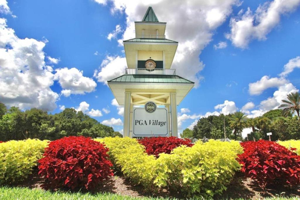 a clock tower in the middle of a garden with flowers at Treasure Coast Getaway in Carlton