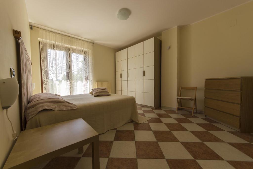 Posteľ alebo postele v izbe v ubytovaní Appartamento Mimosa