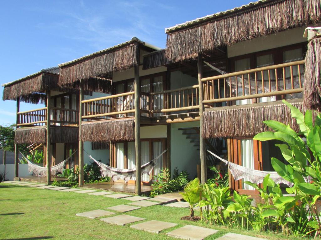 a resort with hammocks in front of it at Pousada Refúgio Eça-Porã in Serra Grande