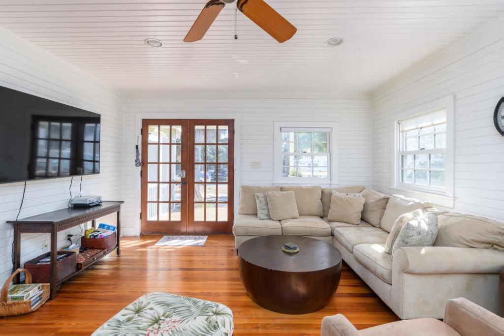a living room with a couch and a table at Longboard House in Tybee Island