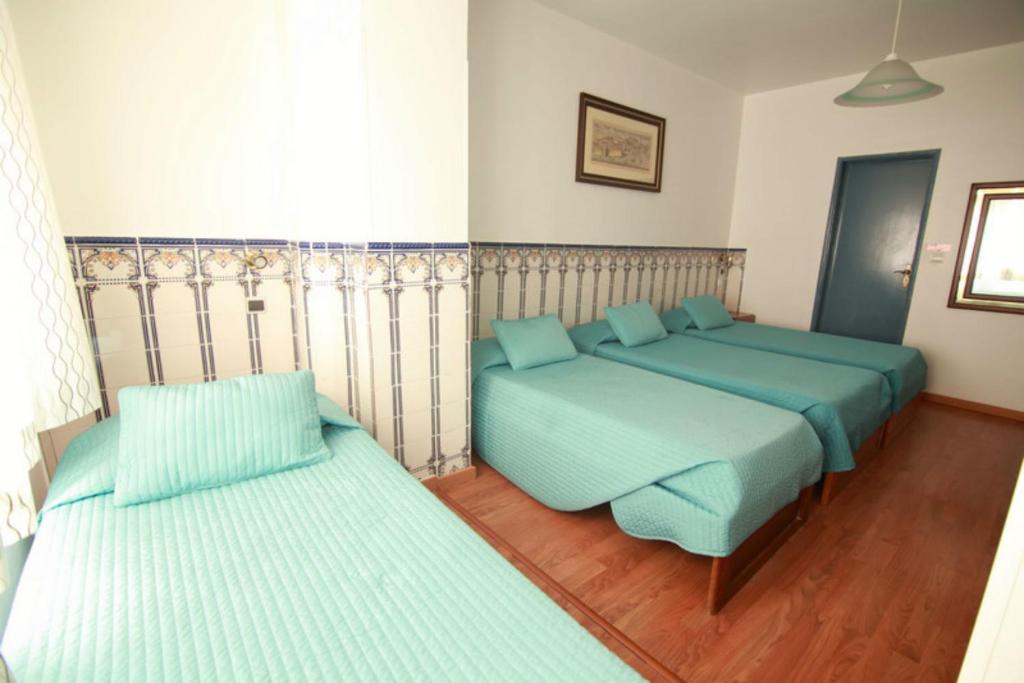 Postel nebo postele na pokoji v ubytování Residencial Joao XXI