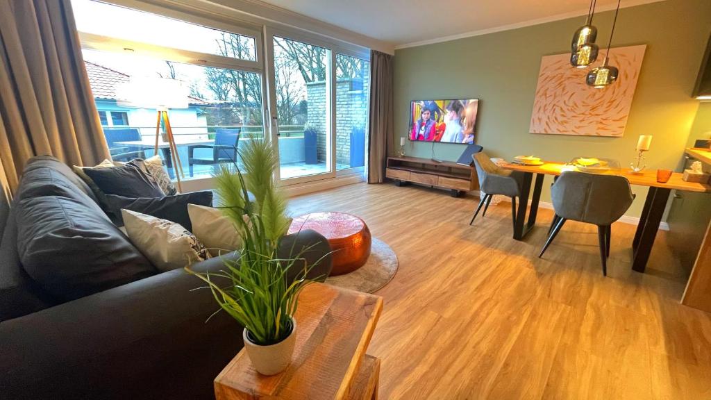 a living room with a couch and a table at Sandliebe in Grömitz