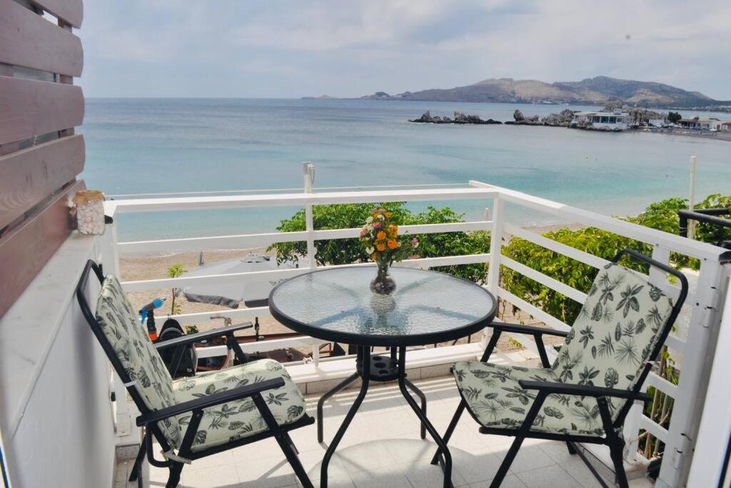 a table and two chairs on a balcony with the ocean at Maroulitsas Sea Esta 2 in Haraki