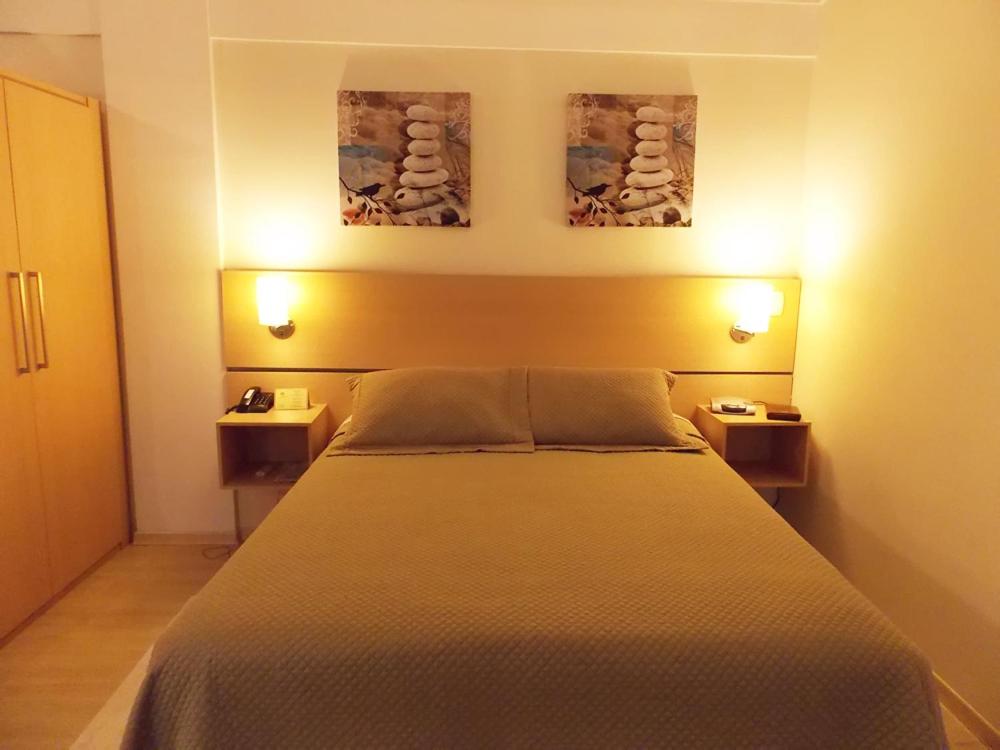Postel nebo postele na pokoji v ubytování Itajubá Flat Hotel