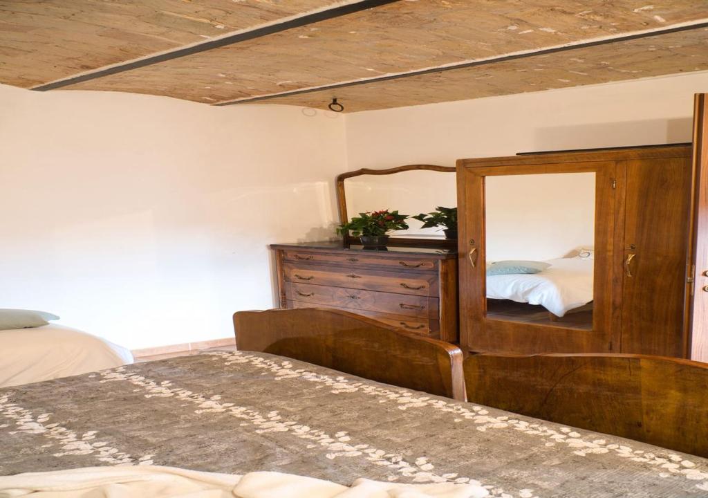 GINESTRA Apartment في San Potito: غرفة نوم مع خزانة ومرآة