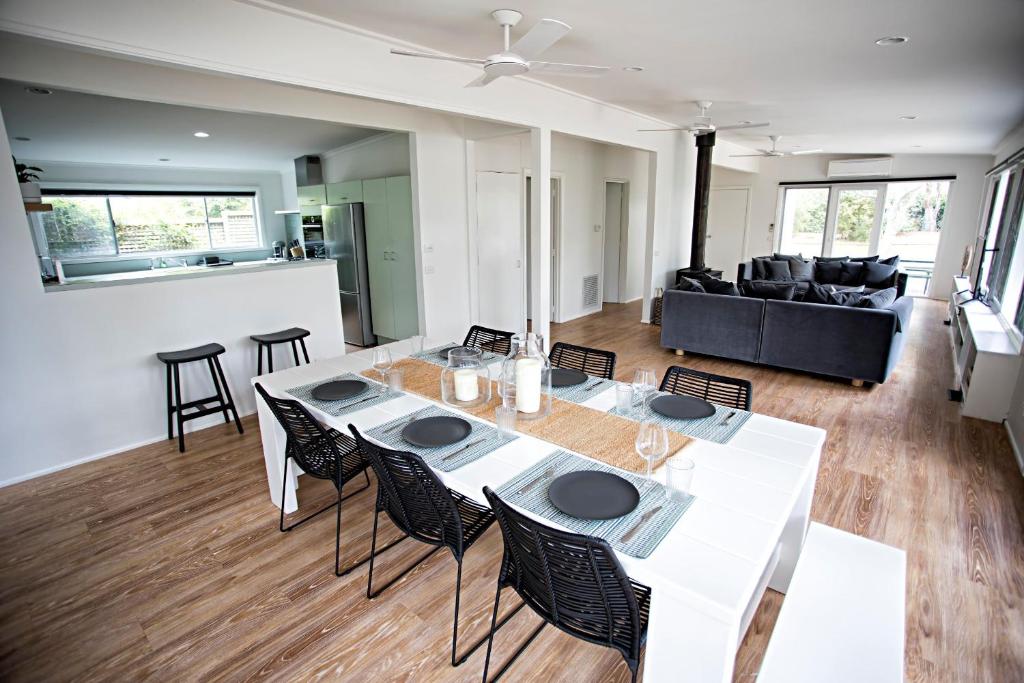 a living room with a table and chairs and a couch at LONSDALE ON GLANEUSE in Point Lonsdale