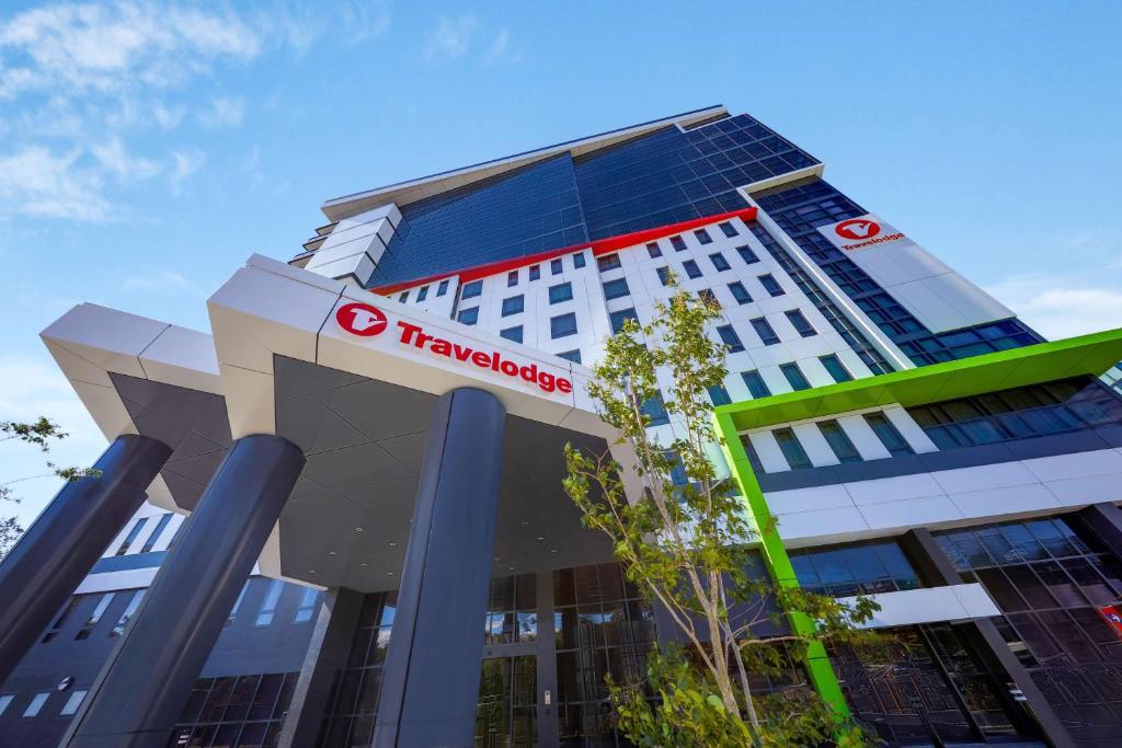 a building with a sign on the front of it at Travelodge Hotel Sydney Airport in Sydney