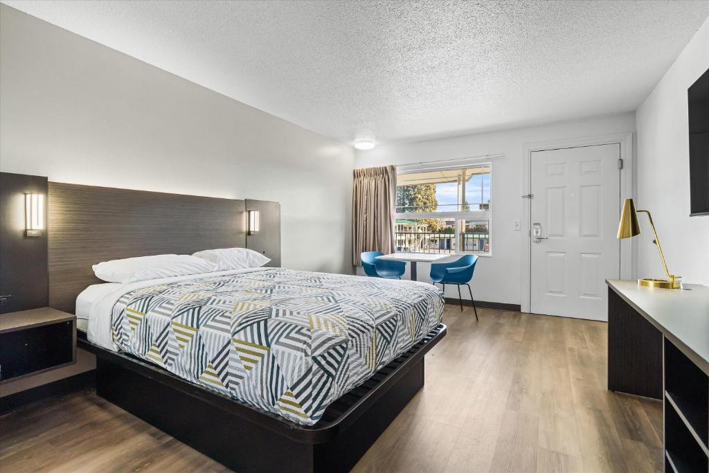 a bedroom with a bed and a desk and a table at Motel 6-Bend, OR in Bend
