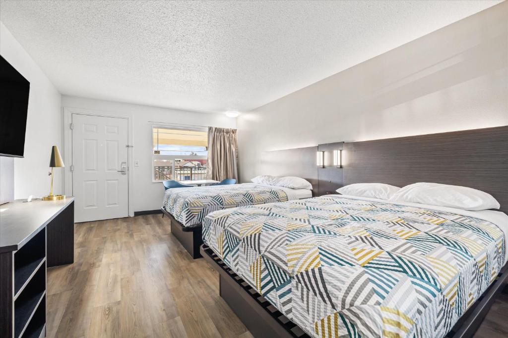 a hotel room with two beds and a desk at Motel 6-Bend, OR in Bend