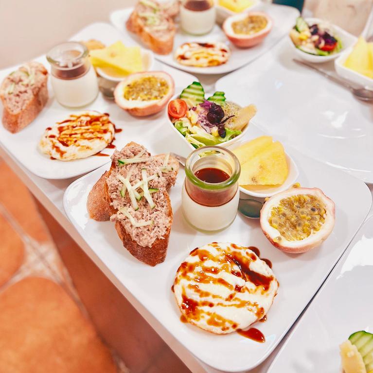a table with many different types of food on it at Qixingtan Xinghai B&amp;B in Dahan