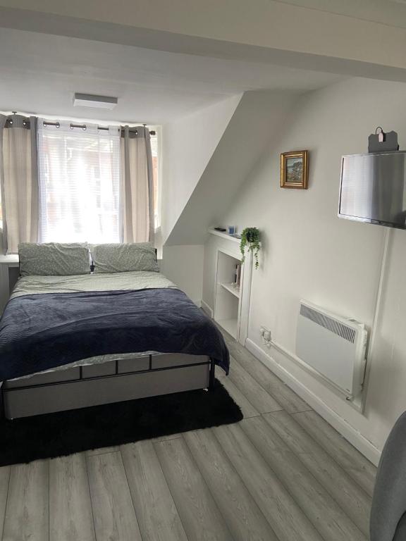 a bedroom with a bed and a window at Studio Flat in Largs