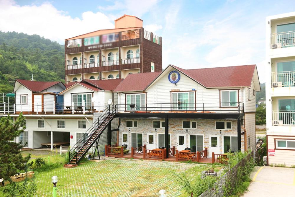 a large building with a staircase in front of it at Matryoshka Pension in Ulsan