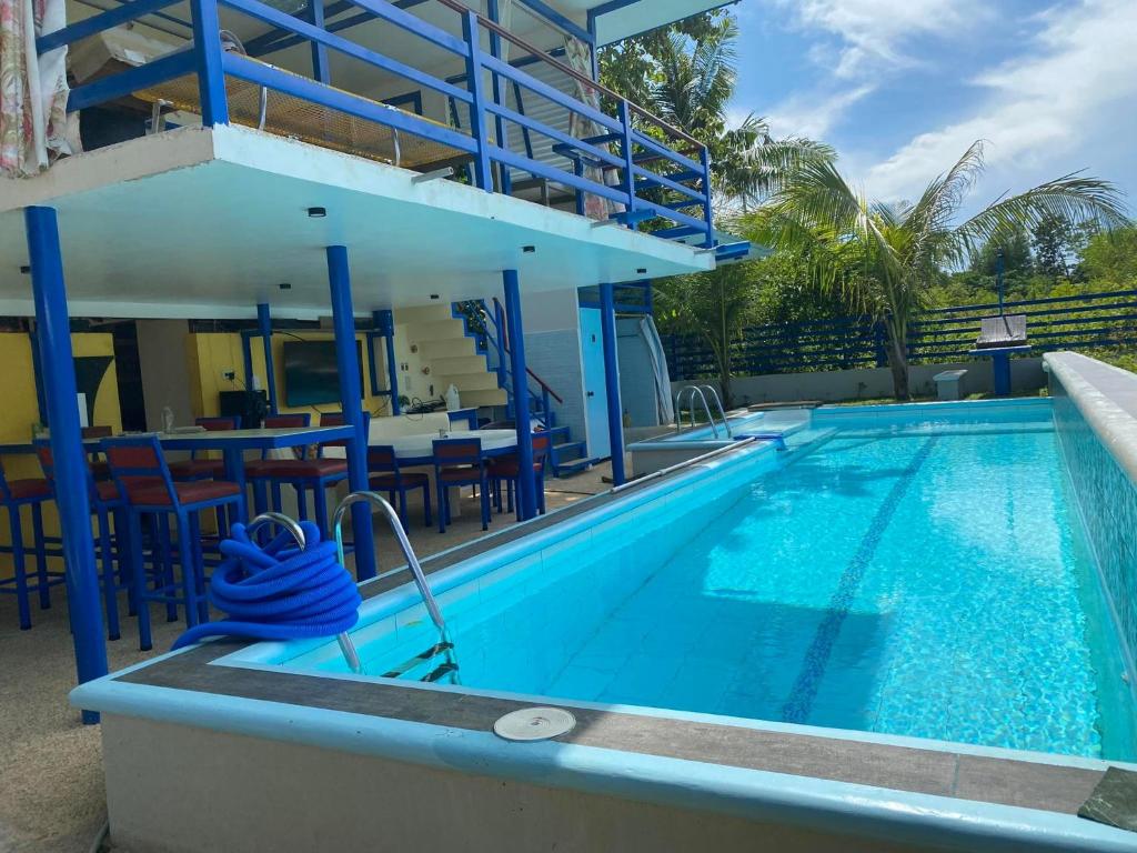 a swimming pool with a table and chairs next to it at D'Schnuggs Place in Panglao Island