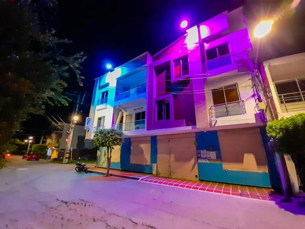 a house with pink and purple lights on it at Hostal El Mirador in Puerto Triunfo