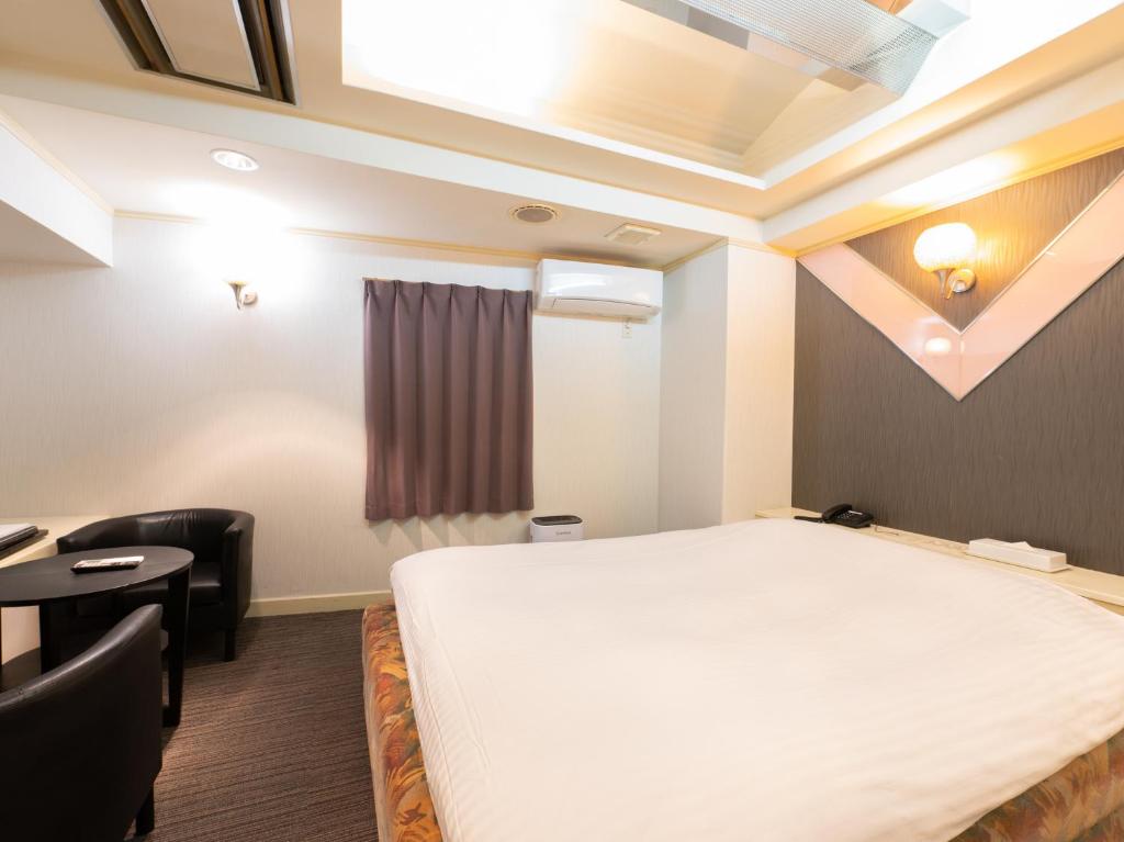 Postel nebo postele na pokoji v ubytování Tabist Hotel Rakuserina