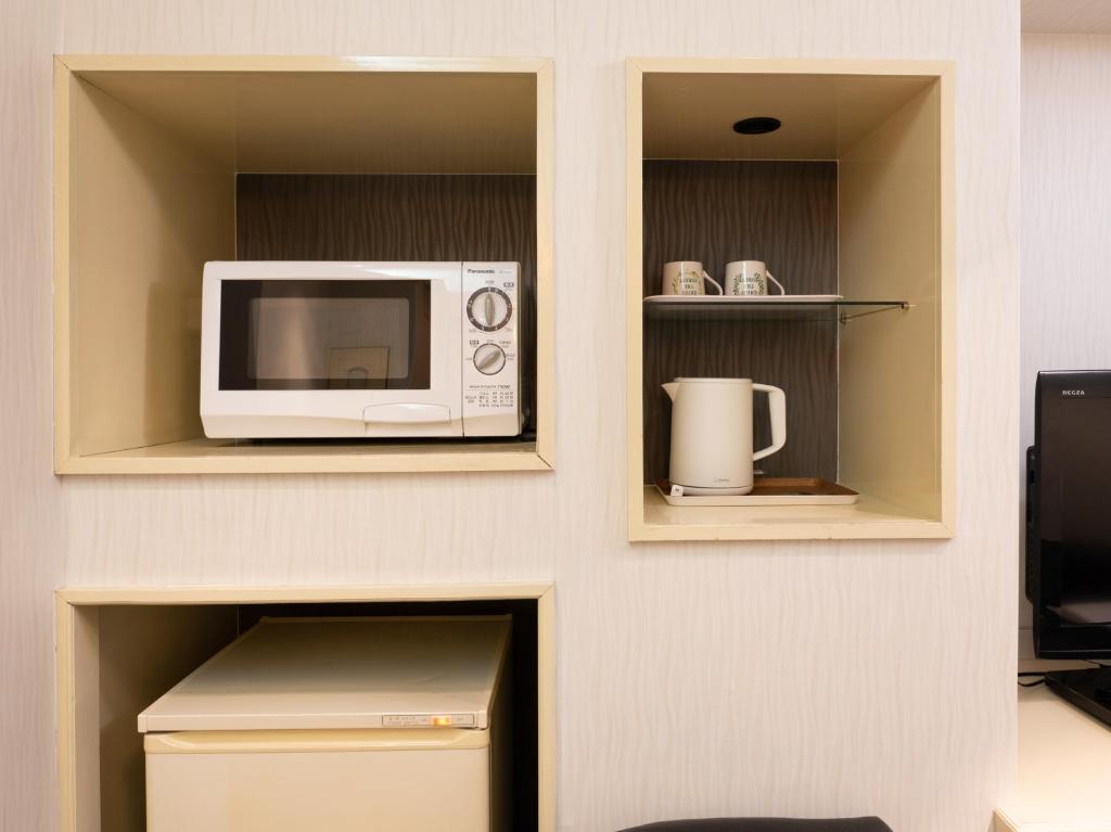 Kuchyň nebo kuchyňský kout v ubytování Tabist Hotel Rakuserina