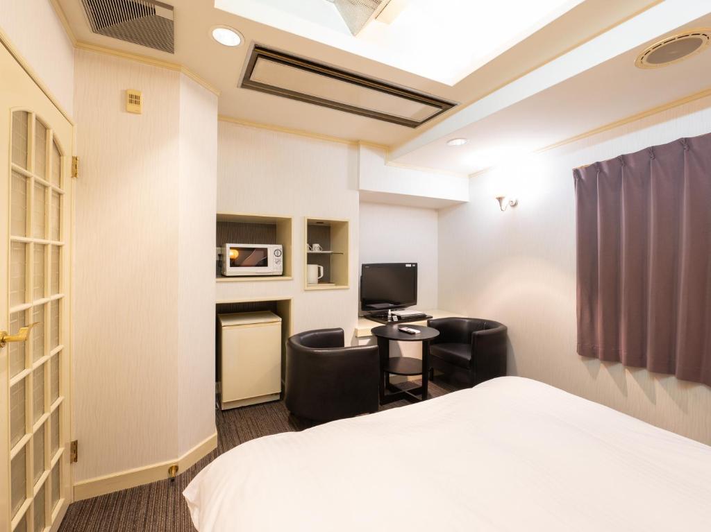 Postel nebo postele na pokoji v ubytování Tabist Hotel Rakuserina