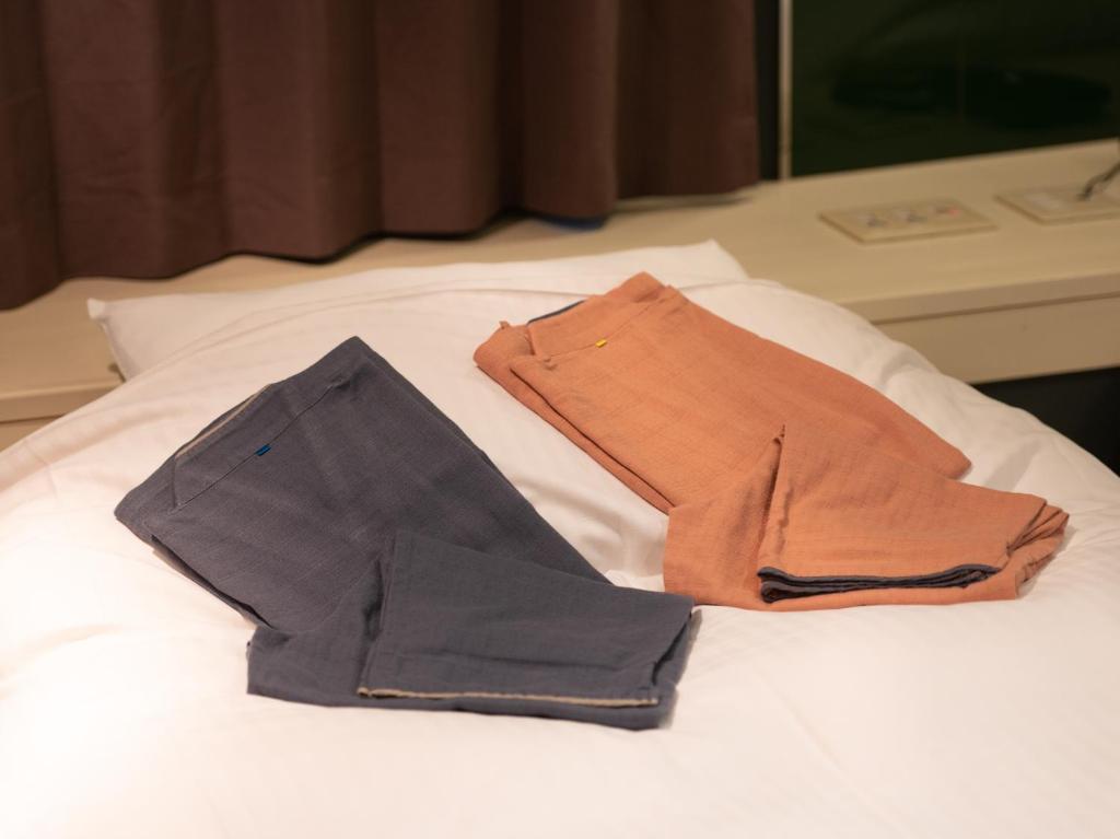 Postel nebo postele na pokoji v ubytování Tabist Hotel Rakuserina