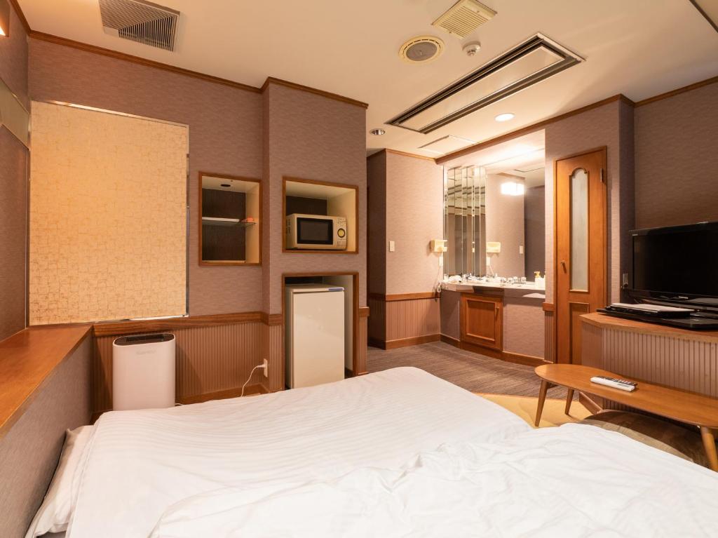 Postel nebo postele na pokoji v ubytování Tabist Hotel Rakuserina