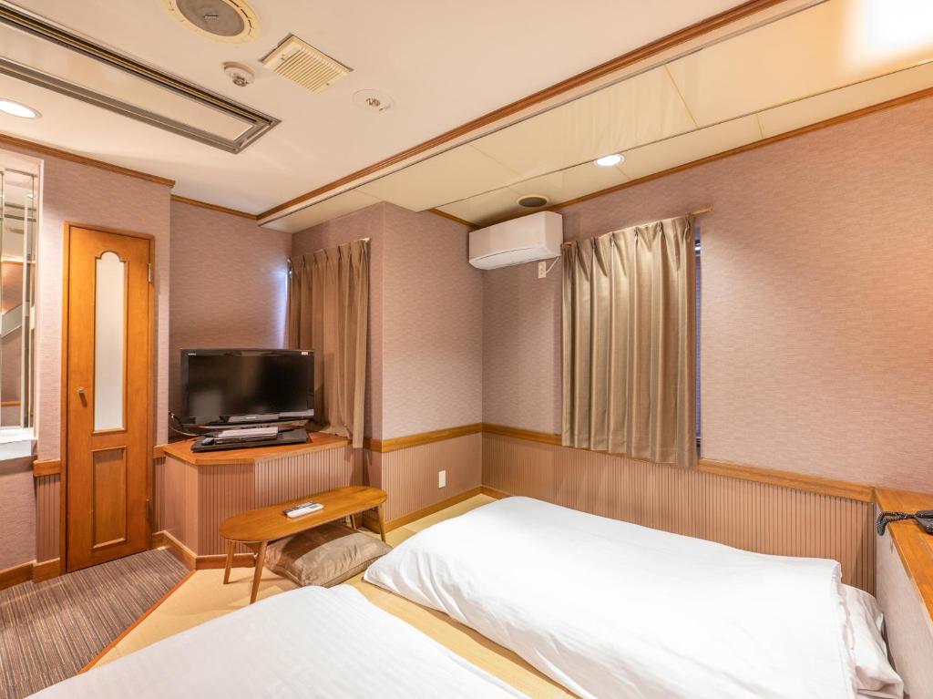 TV a/nebo společenská místnost v ubytování Tabist Hotel Rakuserina
