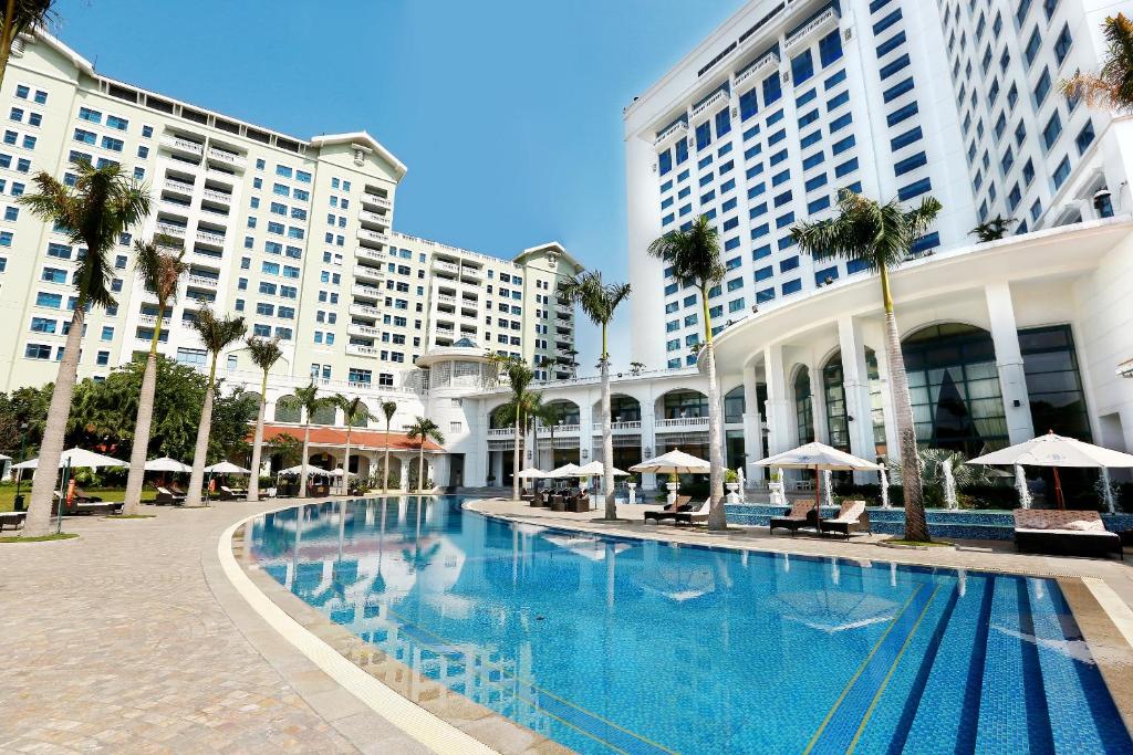 a large swimming pool in front of a building at Hanoi Daewoo Hotel in Hanoi