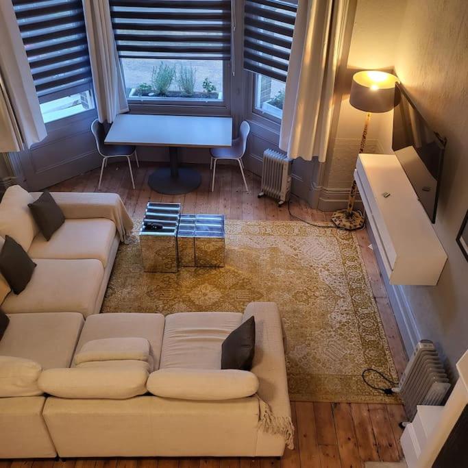 a living room with a white couch and a table at 5 Luxury Spacious Loft - Prime Location - Comfortable Bed & Sofa in Brighton & Hove