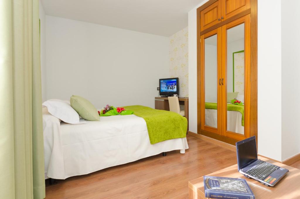 Postel nebo postele na pokoji v ubytování Hotel Apolo