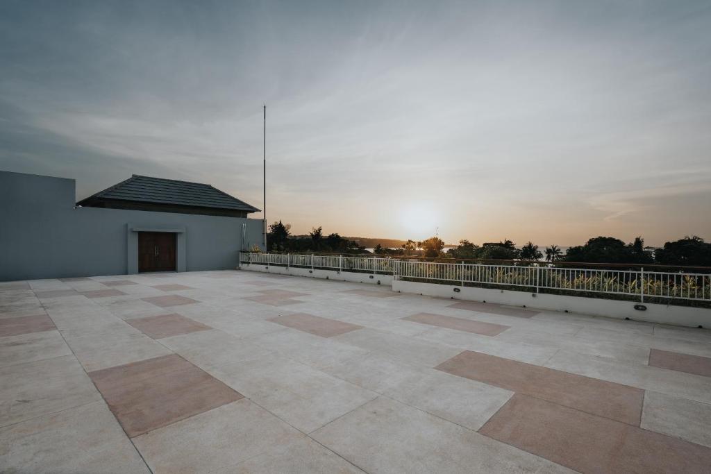 a view of a large patio with the sunset in the background at Anja Jimbaran in Jimbaran