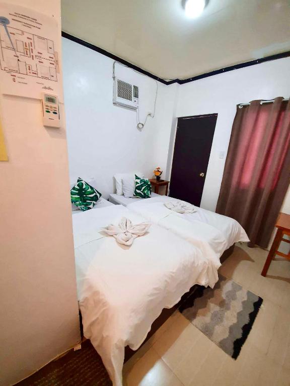 Postel nebo postele na pokoji v ubytování Kalis Viewpoint Lodge Coron