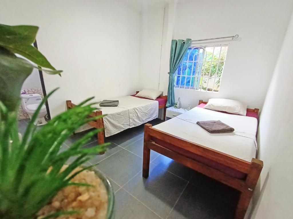 Postel nebo postele na pokoji v ubytování Sam's Guesthouse M'Pai Bay