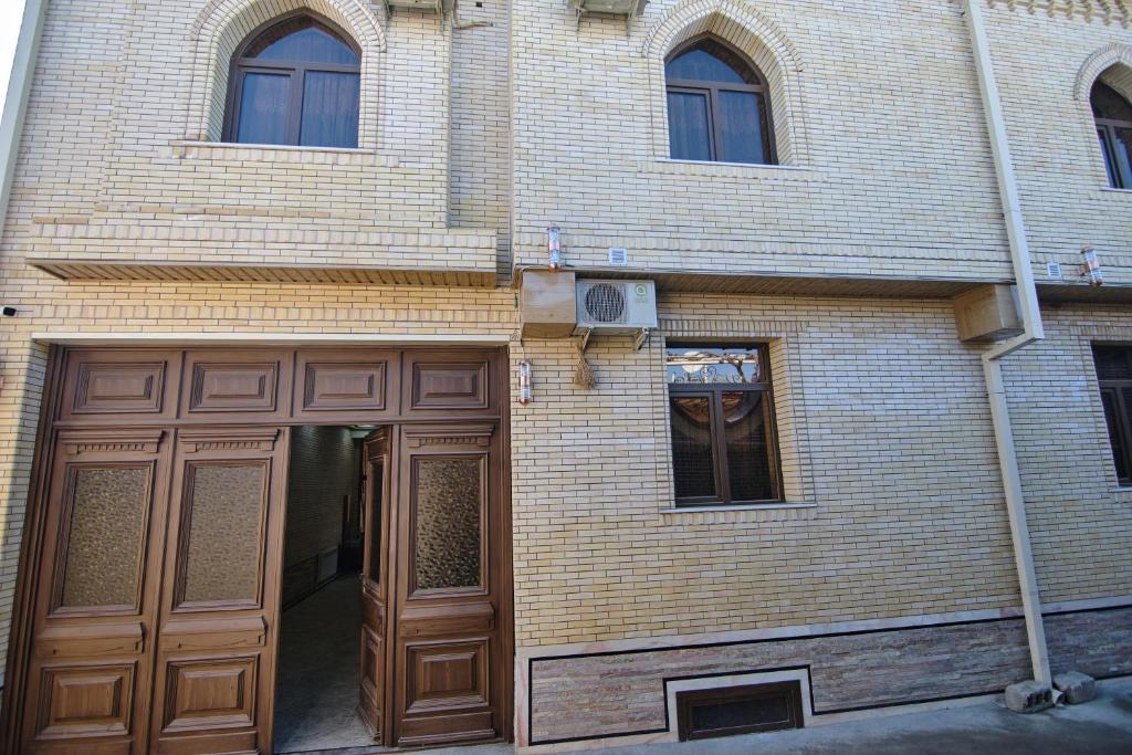 a brick building with brown doors and windows at BRICK PALACE in Samarkand