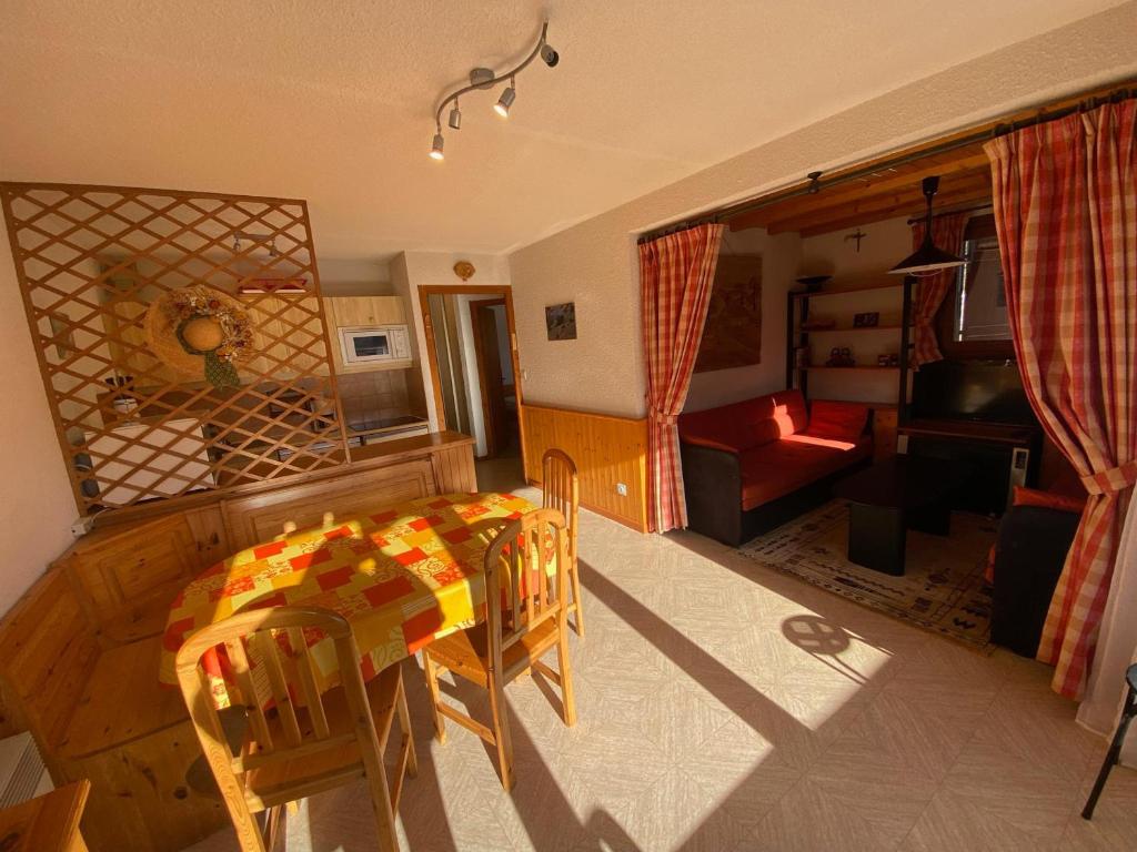 a kitchen and living room with a table and chairs at Appartement Châtel, 3 pièces, 6 personnes - FR-1-198-252 in Châtel