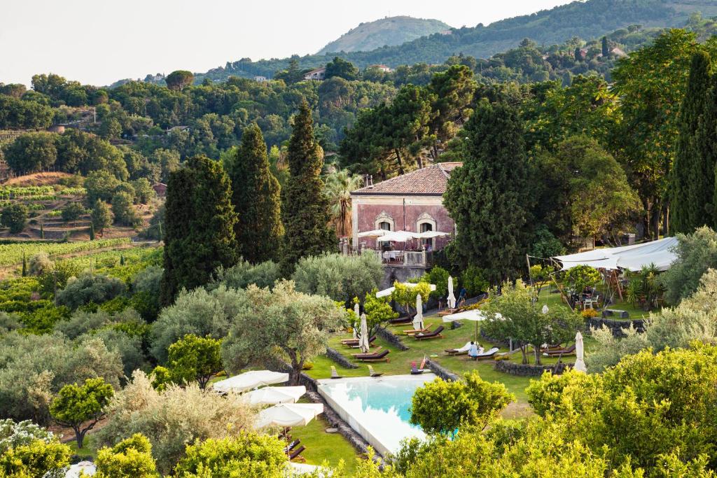 an aerial view of a villa with a swimming pool and trees at Monaci delle Terre Nere in Zafferana Etnea