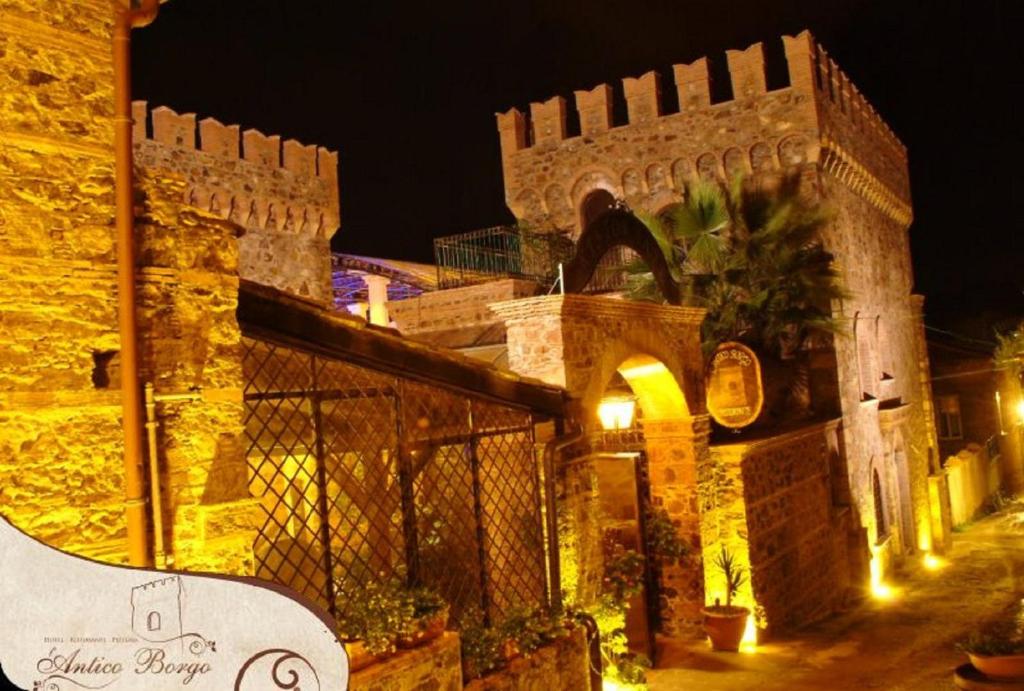 a building at night with a skateboard on a ledge at Residenza L'Antico Borgo Hotel in Filadelfia