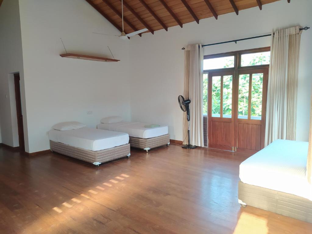 Postel nebo postele na pokoji v ubytování Hostel Residence Bentota