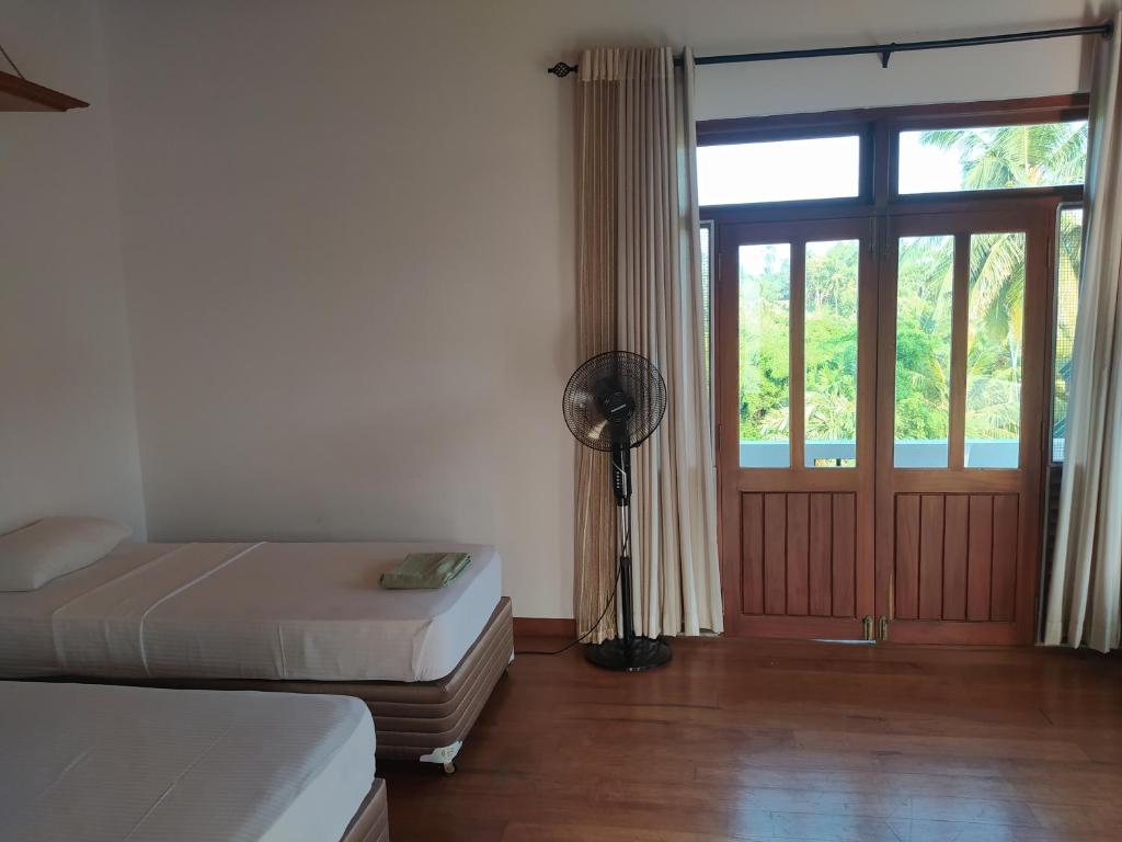 Postel nebo postele na pokoji v ubytování Hostel Residence Bentota