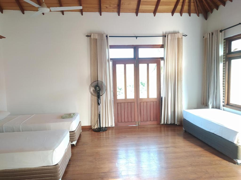 Postel nebo postele na pokoji v ubytování Hostel Residence Bentota