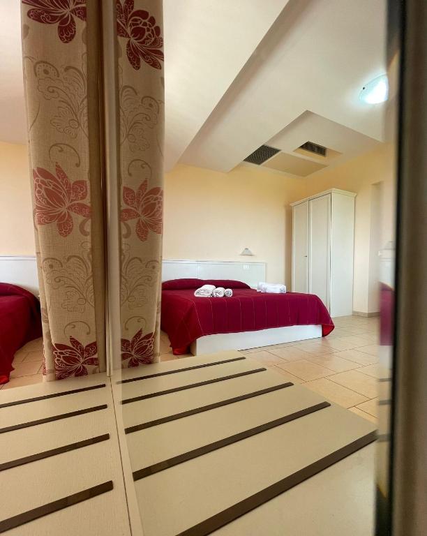A bed or beds in a room at Residenza Domus Aurea Tropea- Vista Mare